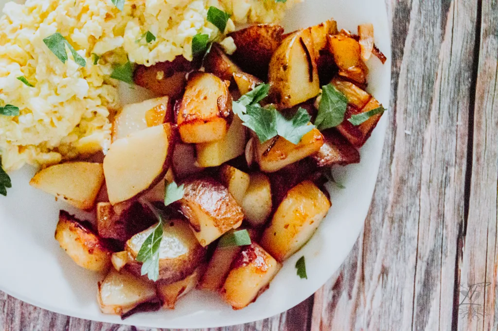Delicious fried leftover potatoes turned into crispy breakfast potatoes served with eggs and toast for breakfast.