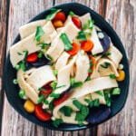 A bowl of freshly cooked homemade egg noodles in savory broth.