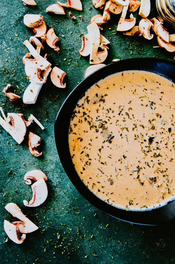 Homemade cream of mushroom soup served in a bowl with a spoon