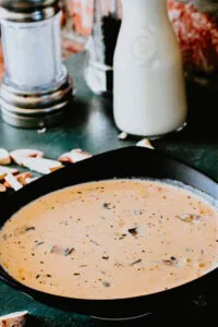 Bowl of creamy homemade mushroom soup with a sprinkle of fresh parsley