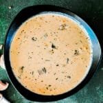 Delicious homemade cream of mushroom soup in a bowl with fresh herbs