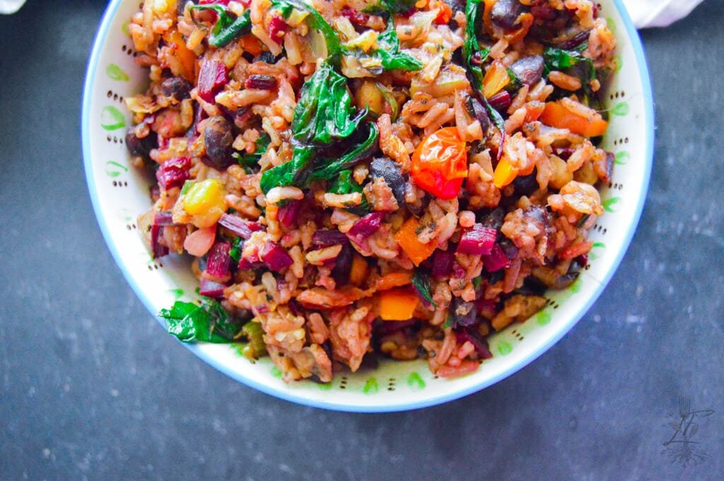 Close-up of vegan dirty rice with garbanzo beans, black beans, and cilantro lime rice.